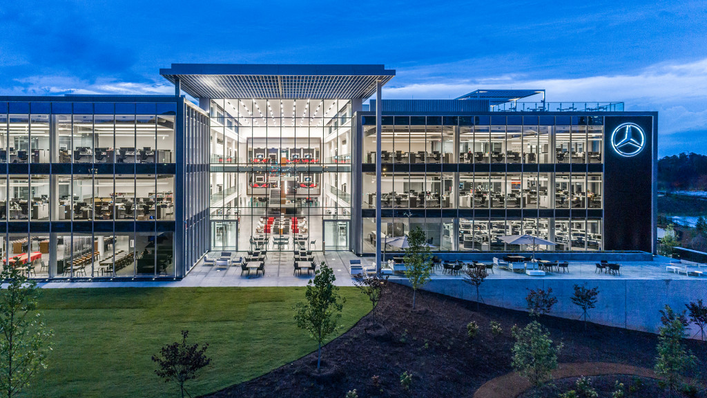 A building with a pool in front.